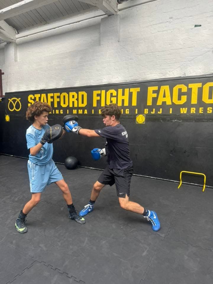 Boxing pad work during a gym session