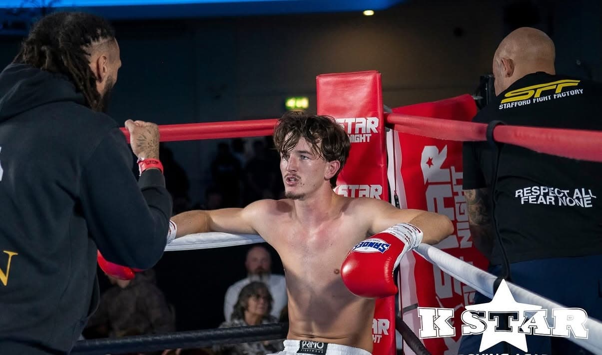 Corner team speaking with a fighter between rounds